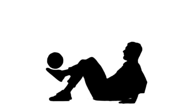 Black silhouette of guy stuffing soccer ball on his leg. — Stock Video