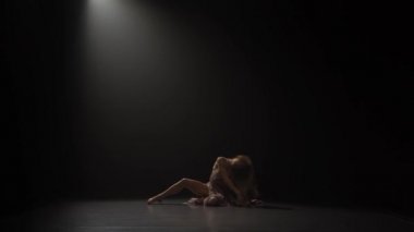 Spot ışığı altında stüdyoda uzun saç dans contemp ile Kadın