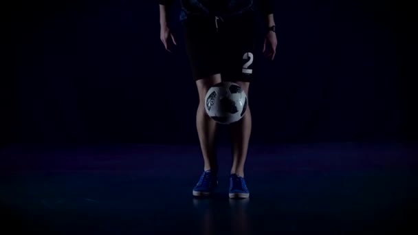 フットボールフリースタイル。クローズアップサッカー選手は、青い夕暮れにボールを詰め足。スローモーション — ストック動画