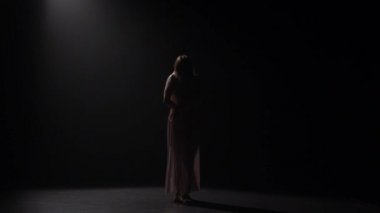 Sofistike kız siyah arka plan karşı stüdyoda dans. Yavaş çekim