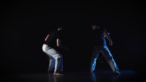 Two men are performing complex of martial art of capoeira. Slow motion — Stock Video