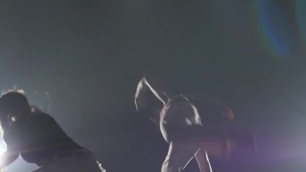 Gracieuze dames beoefenen Capoeira in de duisternis tegen Spotlight in Studio. Close-up slow motion. — Stockvideo