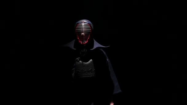 Erfahrener Kendo-Krieger, der aus der Dunkelheit ans Licht kommt. Zeitlupe — Stockvideo