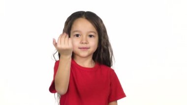 Küçük dişi beyaz arka planda elini kendine sallıyor. Yavaş çekim