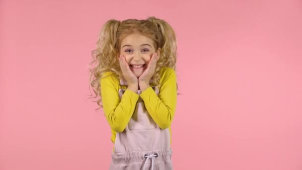 Cute little girl is surprised and clapping her hands — Stock Video