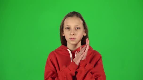 Little female is clapping her hands and then smiling in studio. Greenscreen — Stock Video