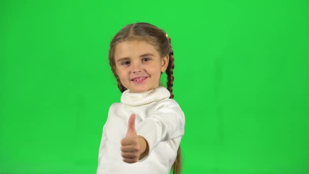 Lovely girl shows thumbs up like in studio on green screen — Stock Video