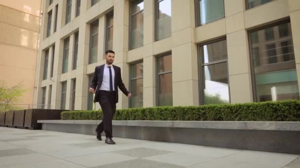 Ο ευτυχισμένος επιχειρηματίας χορεύει στο δρόμο κοντά στο κέντρο του γραφείου φορώντας κουστούμι που γιορτάζει τα επιτεύγματά του. Σταθεροποιήθηκα. — Αρχείο Βίντεο