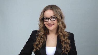 Bussines kadın coquettishly gülümsüyor, göz kırpma, elini dalgalar ve kendine çağırır, yavaş hareket