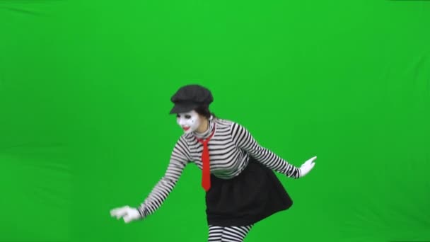 Mime girl has found dandelion, blowing on it. Chroma key. — Stock Video
