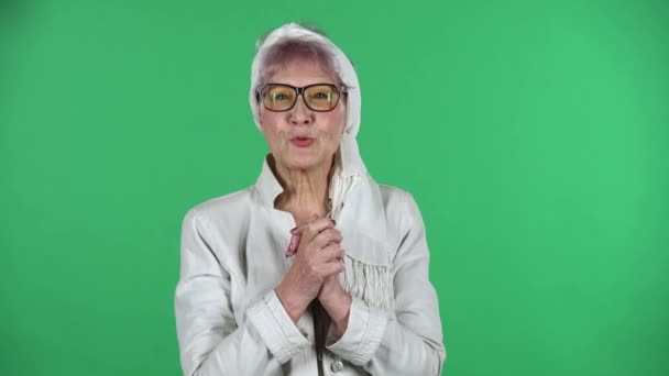 Portrait of old stylish woman is looking at the camera with excitement, then celebrating her victory triumph isolated over green background. — Stock Footage Portrait of old stylish woman is looking at the camera with excitement, then celebrating her victory triumph isolated over green background. Royalty Free Stock Video