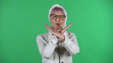 Yaşlı ve şık bir kadının portresi, ellerini çapraz yapıp X şeklini almaktır. Bu da demek oluyor ki, yeşil arka planda izole edilmemiş..
