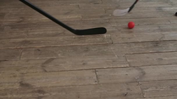Hockey sticks hitting hockey red ball. Slow motion. Close up. — Stock Video