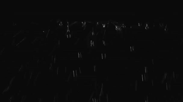 Streams of water flow down the canopy at night in a dark studio. Raindrops break on the surface and form a lot of splashes. Close up shot in slow motion. — Stock Video