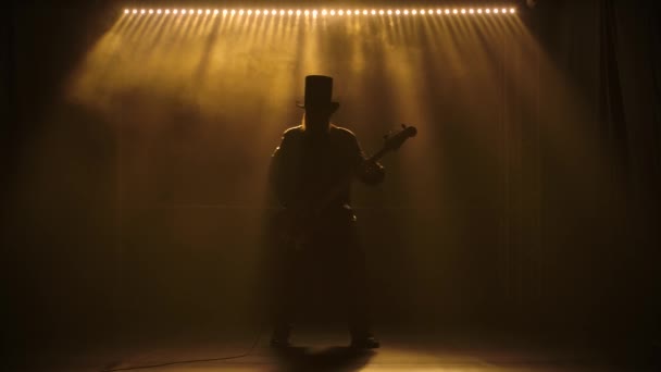 Le guitariste joue sur scène. Performance au ralenti. Un homme coiffé d'une barbe joue énergiquement de la guitare électrique. Concert métal ou rock. Spectacle live. — Video