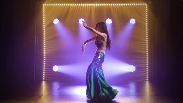 Arabská břišní tanečnice v exotickém tance. Natočeno v tmavém studiu s kouřem a neonovým osvětlením. Zpomalený pohyb. — Stock video