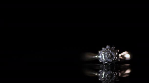 Gold Diamond Engagement Ring Being Lit Black Reflective Background — Stock Video