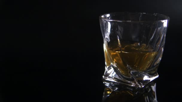 Modern Glas Torktumlare Fylld Med Whisky Mörk Reflekterande Bakgrund — Stockvideo