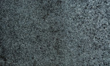 Farklı boyutlarda gri beyaz ve siyah renkli küçük taşlardan oluşan gözenekli bir doku. Bulanık odak