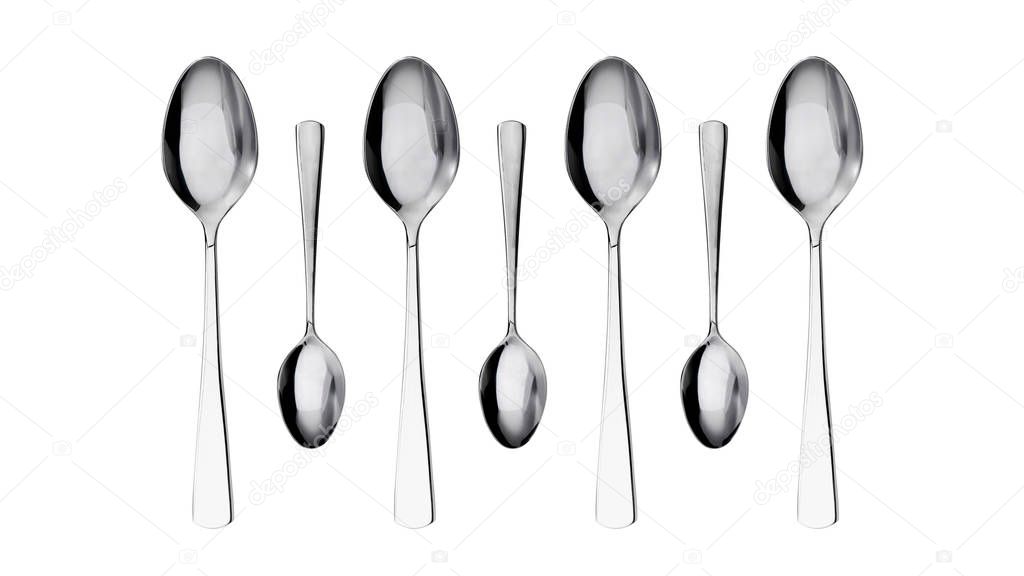 Symmetrical close-up of group of small and large spoons on white surface