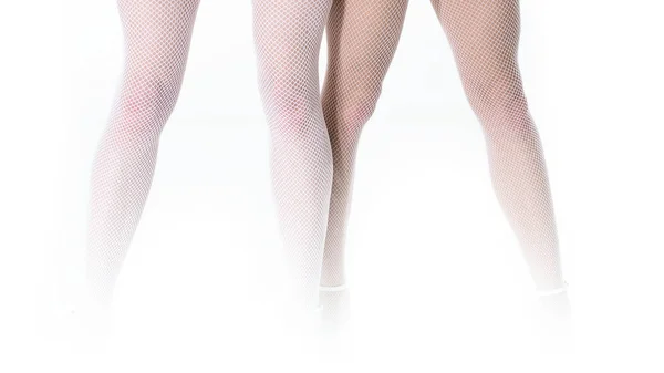 Fechar-se de duas belas mulheres finas pernas em meias meia-calça branca sexy em pé no fundo branco — Fotografia de Stock