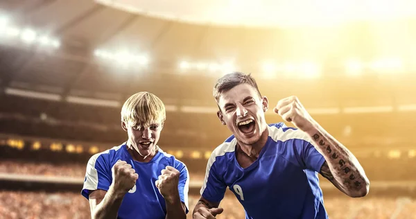 Happy soccer player celebrate a victory on a professional football stadium