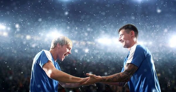 Soccer players are celebrating a victory on the professional stadium while its snowing. Stadium and crowd are made in 3d.