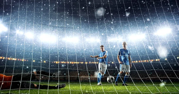 Intense soccer moment in front of the goal on the professional soccer stadium while it\'s snowing. Stadium and crowd are made in 3D.