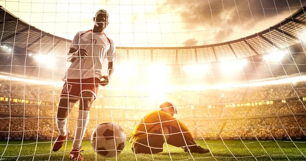 Intense soccer moment in front of the goal on the professional soccer stadium while the sun shines. Stadium and crowd are made in 3D.