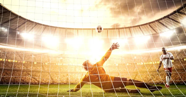 Intense soccer moment in front of the goal on the professional soccer stadium while the sun shines. Stadium and crowd are made in 3D.