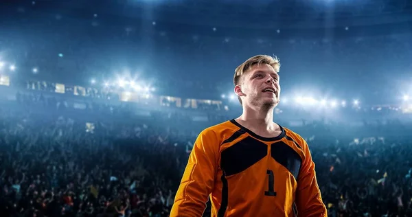 Happy soccer player celebrate a victory on a professional football stadium