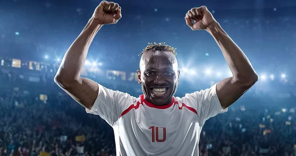 Happy soccer player celebrate a victory on a professional football stadium