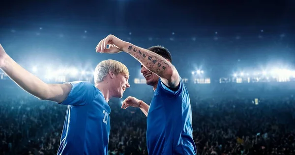 Happy soccer player celebrate a victory on a professional football stadium