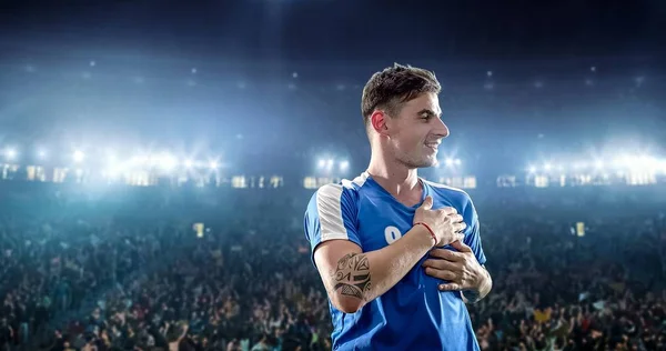 Happy soccer player celebrate a victory on a professional football stadium