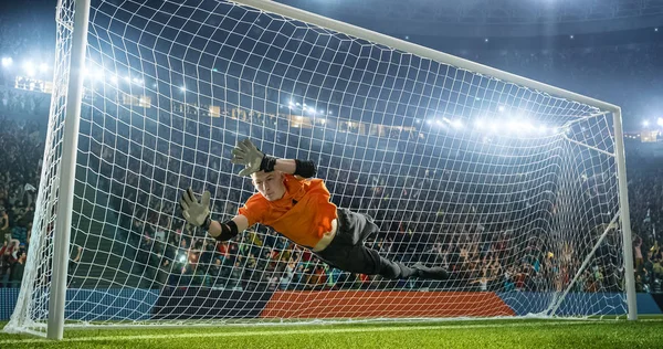 Soccer goalkeeper in action on the soccer stadium. He wear unbranded sports clothes. Stadium and crowd made in 3D.