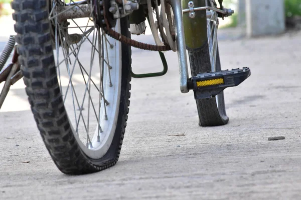 Closeup view of bicycle flat tire on pavement.