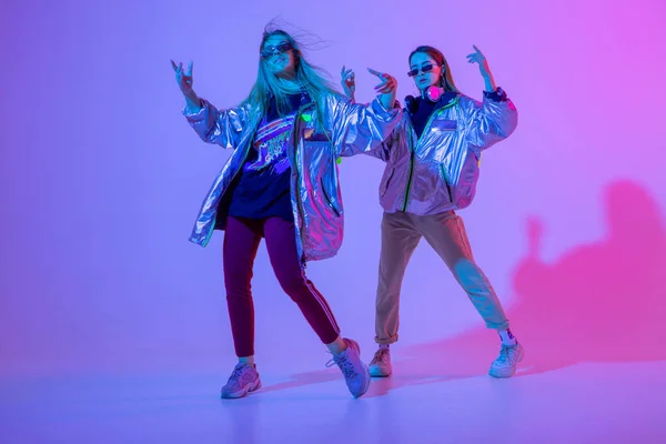 Stüdyoda renkli neon arka planda dans eden zarif kızlar. Müzik dj poster tasarımı.