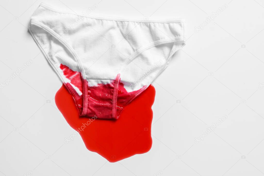 Menstrual fluid and womens underwear on white background, concept photo for womens or feminist blog, ad womens apps