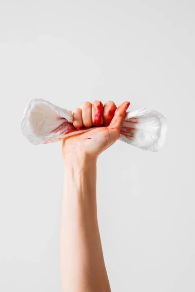 Womans fist as symbol of feminism with used menstrual pad, concept photography for feminist blog or poster