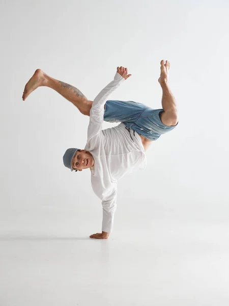 Νεαρός χορευτής στέκεται στο ένα χέρι χορεύοντας χιπ-χοπ απομονωμένος σε λευκό φόντο. Αφίσα σχολής χορού Break — Φωτογραφία Αρχείου
