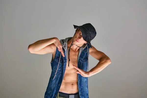 Joven chico breakdancer en panama hat bailando hip-hop en estudio aislado sobre fondo gris. Escuela de baile cartel —  Fotos de Stock