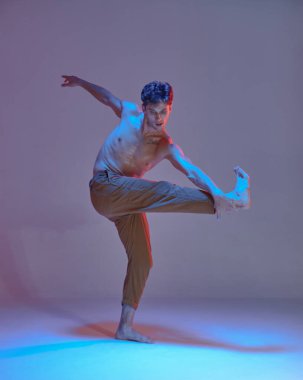 Havalı break dansçı genç adam neon ışıkta üstsüz hip-hop yapıyor. Dans okulu posteri. Break dans dersleri