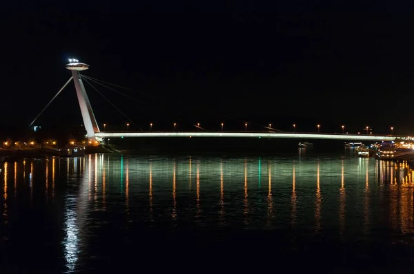 Night view of the lighted SNP bridge over Danube river. Bratislava, Slovakia Stock Photo