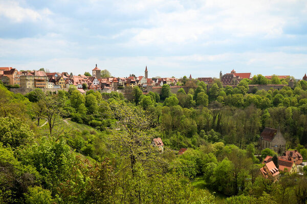 Wall and town of Roghenburg on a brigh sunny spring day in Germany.