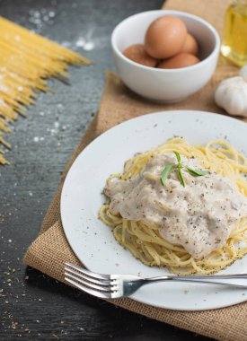 Ahşap masa arka plan üzerinde beyaz plaka spagetti cabonara.