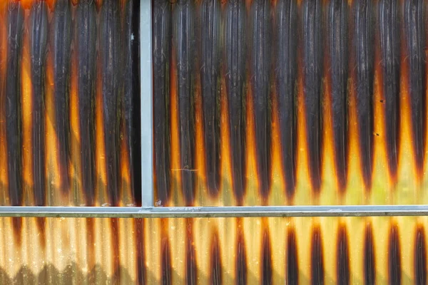 Old and stained acrylic corrugated sheets in a abandoned greenhouse