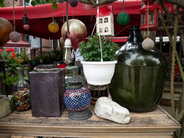 some interesting stuff, goods near thrift shop for derocation. old lanterns, huge bottle, some vases, decorative stones