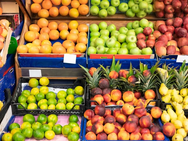 fruit counters in super market shopping mall - apples, peaches, oranges, lemons, mandarines. front shot