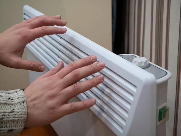 Two Frozen Hands Warming Home Hot Electric Heater Low Temperature — Stock Photo, Image