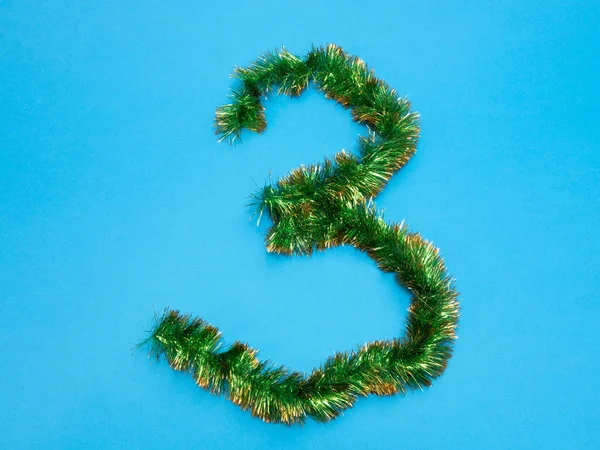 Número Três Feito Ouropel Árvore Natal Verde Fundo Azul — Fotografia de Stock